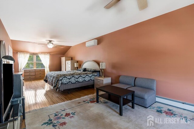 124 6th Ave, Middlesex, NJ 08846 - bedroom with baseboard heating, a wall mounted AC, vaulted ceiling, wood finished floors, and ceiling fan