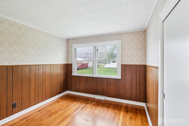 192 Lakeview Ave, Piscataway, NJ 08854 - empty room with light wood-style flooring, wallpapered walls, wainscoting, and ornamental molding