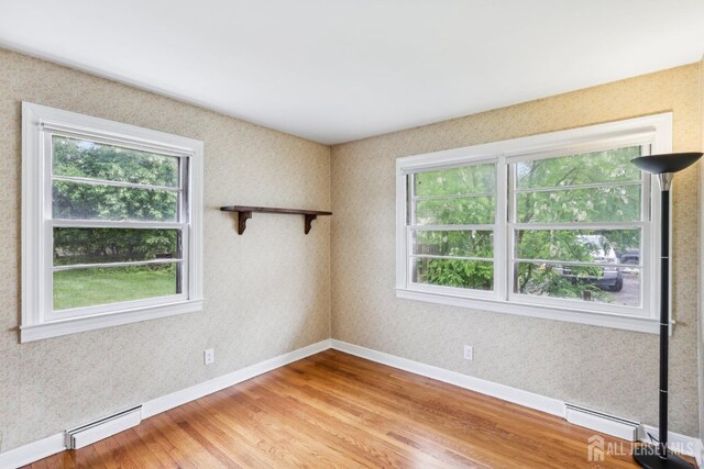192 Lakeview Ave, Piscataway, NJ 08854 - empty room with baseboard heating, plenty of natural light, and light wood-style floors