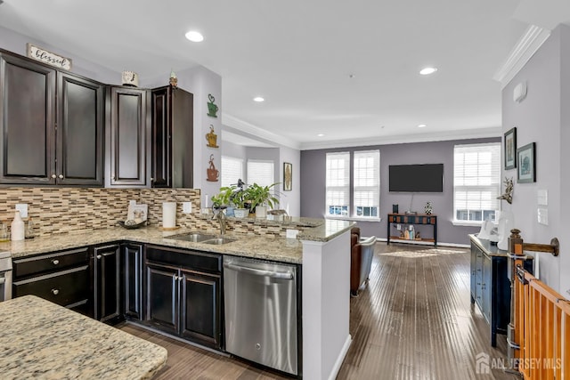 kitchen featuring dark wood-type flooring, ornamental molding, decorative backsplash, stainless steel dishwasher, and a sink