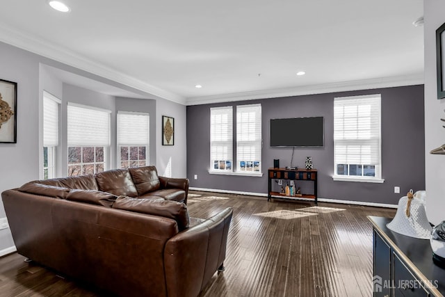 living room featuring a wealth of natural light, dark wood finished floors, and crown molding