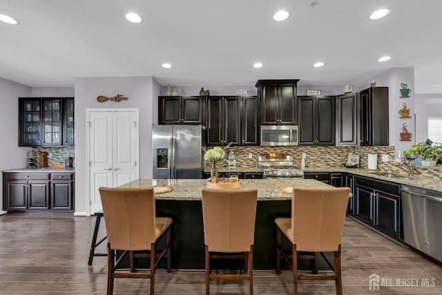 kitchen featuring a sink, dark wood finished floors, a kitchen island, and stainless steel appliances