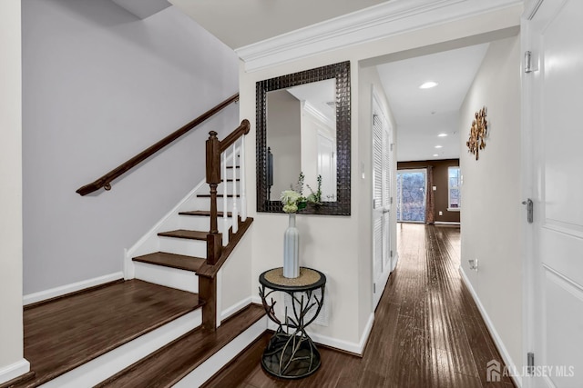 hallway with stairway, wood finished floors, baseboards, recessed lighting, and ornamental molding