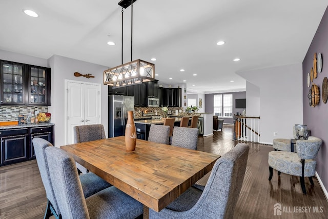 dining space with recessed lighting, baseboards, and wood finished floors