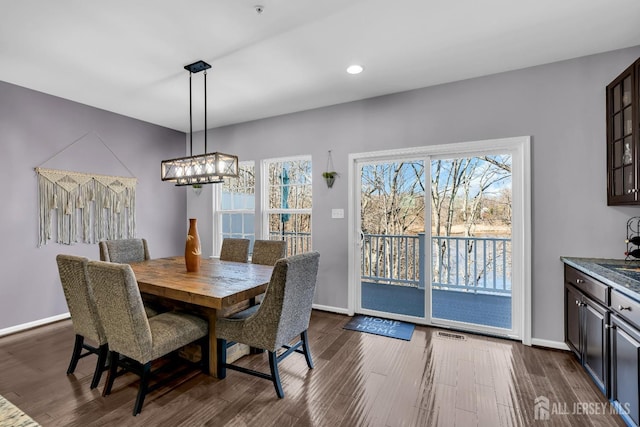 dining space with dark wood finished floors, visible vents, recessed lighting, and baseboards