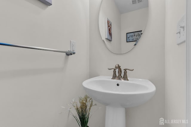 bathroom featuring a sink and visible vents