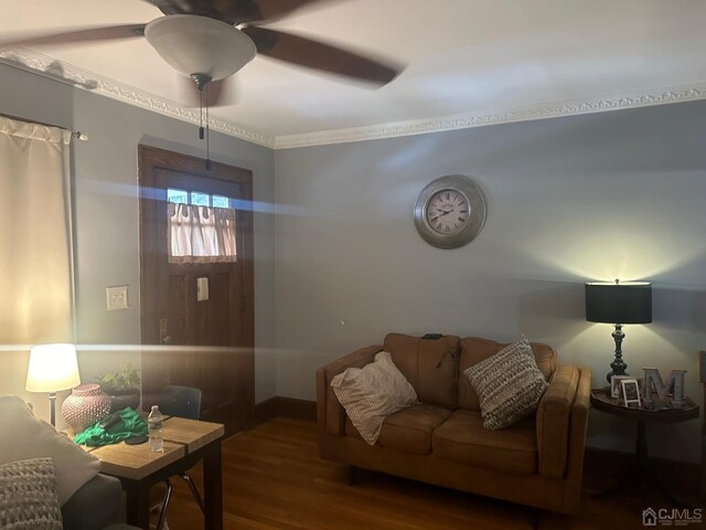 living room featuring hardwood / wood-style flooring, ceiling fan, and ornamental molding