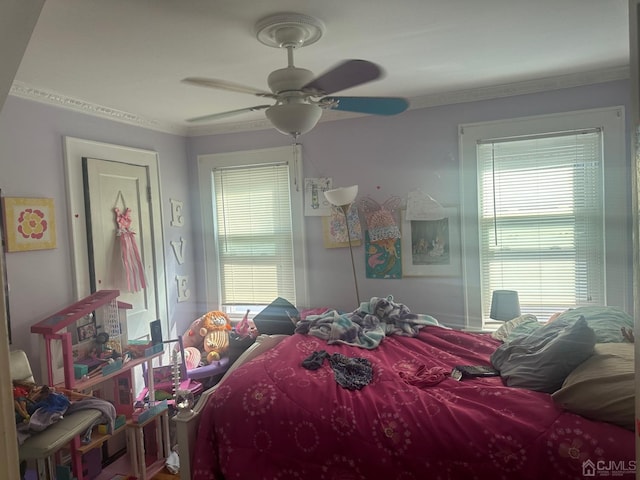 bedroom with ceiling fan and crown molding