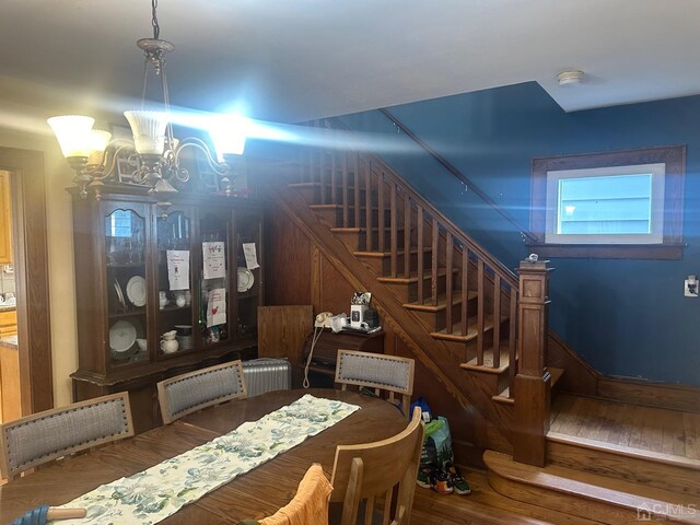 dining room featuring wood-type flooring and a chandelier