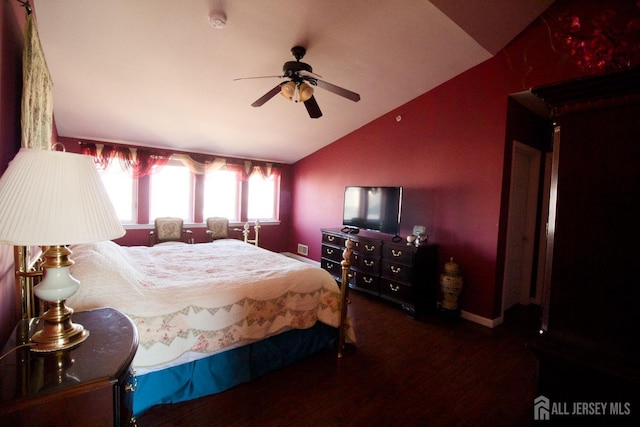 bedroom with a ceiling fan, baseboards, vaulted ceiling, and wood finished floors
