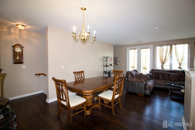 dining space featuring an inviting chandelier, wood finished floors, and baseboards