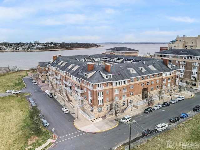 birds eye view of property with a water view