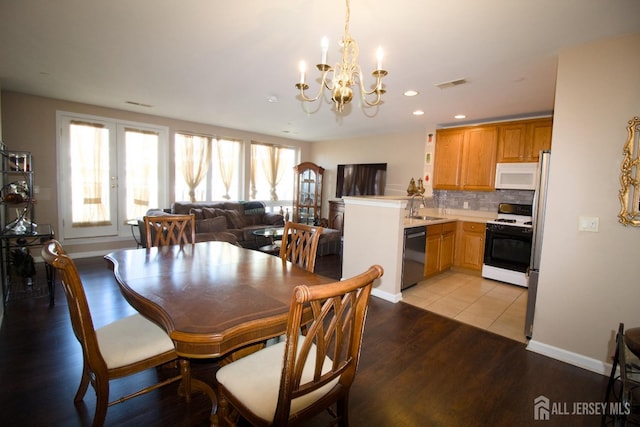 dining room with visible vents, recessed lighting, light wood finished floors, baseboards, and a chandelier