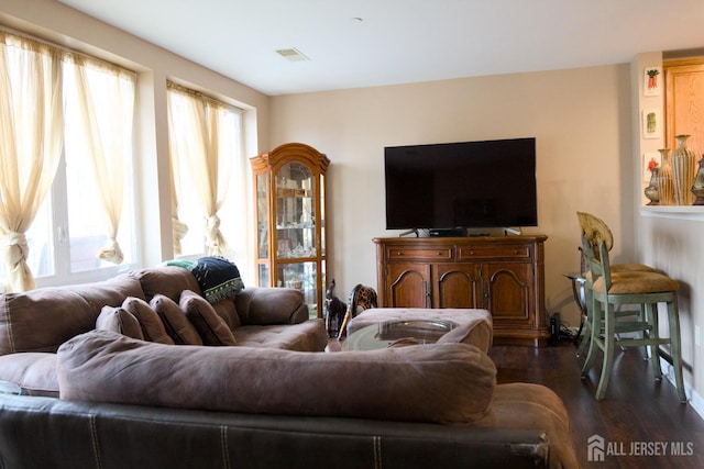 living area with wood finished floors and visible vents