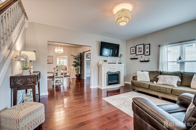 9 Sedgwick St, Jamesburg, NJ 08831 - living area with a chandelier, dark wood-type flooring, and a fireplace
