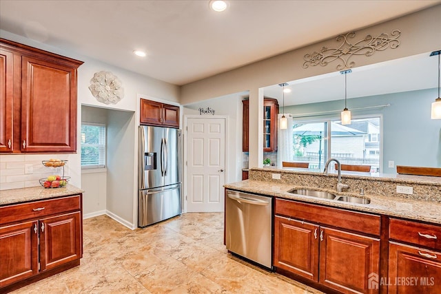 9 Sedgwick St, Jamesburg, NJ 08831 - kitchen with stainless steel appliances, light stone countertops, decorative backsplash, hanging light fixtures, and plenty of natural light