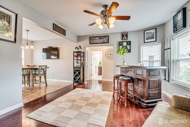 9 Sedgwick St, Jamesburg, NJ 08831 - bar area with dark wood-type flooring, a ceiling fan, and healthy amount of natural light