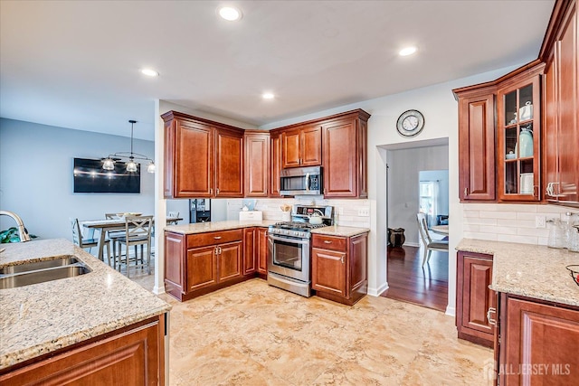 9 Sedgwick St, Jamesburg, NJ 08831 - kitchen with stainless steel appliances, light stone countertops, tasteful backsplash, glass insert cabinets, and recessed lighting