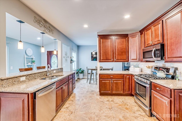 9 Sedgwick St, Jamesburg, NJ 08831 - kitchen with appliances with stainless steel finishes, light stone countertops, brown cabinets, a peninsula, and pendant lighting