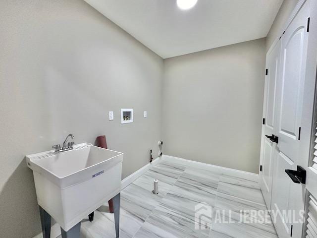 laundry area with gas dryer hookup, sink, and hookup for a washing machine