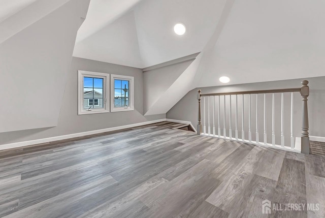 bonus room featuring hardwood / wood-style flooring and lofted ceiling