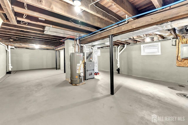 basement with electric panel, water heater, and heating unit