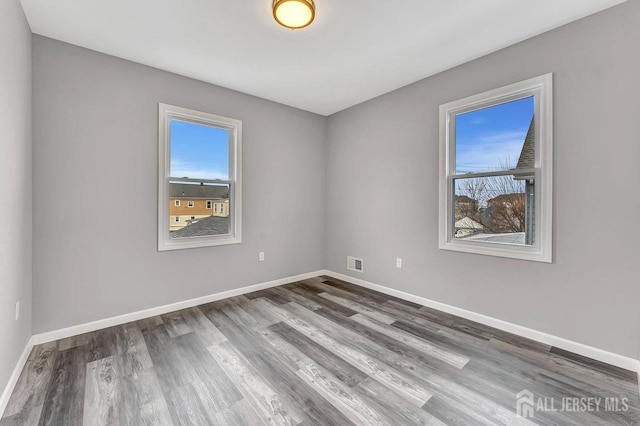 spare room featuring hardwood / wood-style flooring