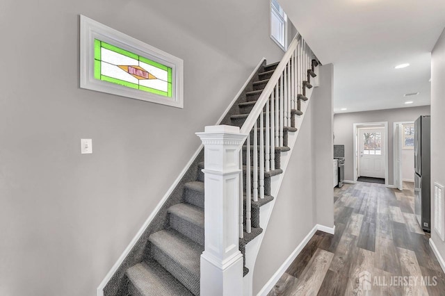 stairs with wood-type flooring