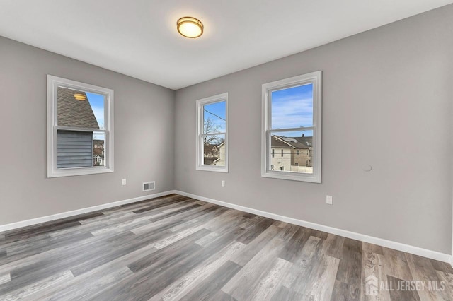 empty room with light hardwood / wood-style floors