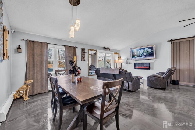 dining area featuring a barn door, a chandelier, lofted ceiling, a textured ceiling, and a baseboard radiator