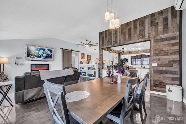 dining area featuring lofted ceiling, wood walls, a wall mounted air conditioner, and a barn door