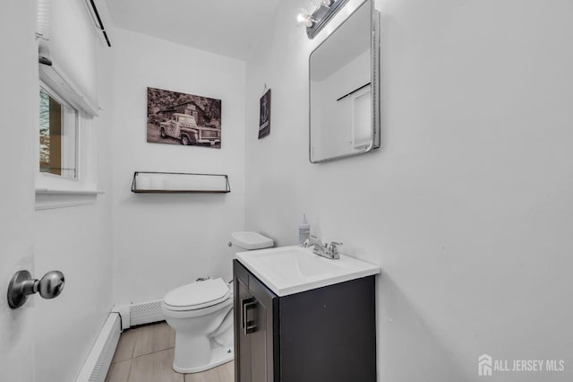 bathroom featuring toilet, tile patterned flooring, vanity, and a baseboard radiator