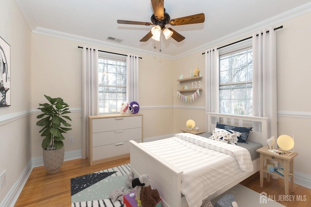 bedroom with multiple windows, ornamental molding, light hardwood / wood-style floors, and ceiling fan