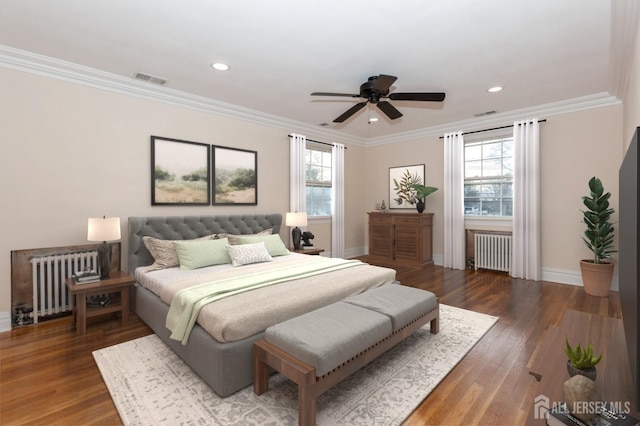 bedroom with ornamental molding, radiator, dark wood-type flooring, and ceiling fan