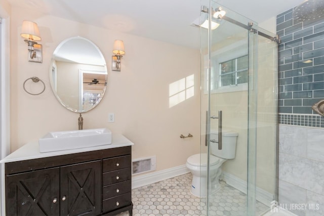 bathroom featuring vanity, an enclosed shower, tile patterned floors, and toilet