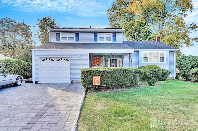 front facade with a front yard and a garage