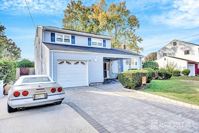 front facade featuring a front yard and a garage