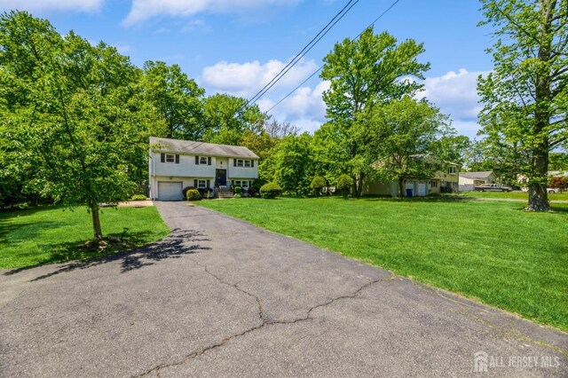 350 Church Ln, North Brunswick, NJ 08902 - split foyer home with asphalt driveway, a garage, and a front yard