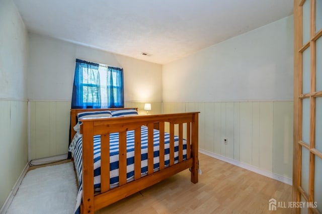350 Church Ln, North Brunswick, NJ 08902 - bedroom with wainscoting and wood finished floors