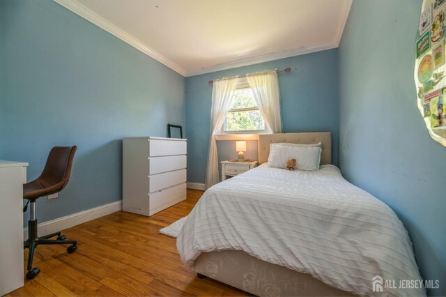 350 Church Ln, North Brunswick, NJ 08902 - bedroom with crown molding, wood finished floors, and baseboards