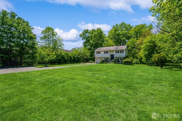 350 Church Ln, North Brunswick, NJ 08902 - view of grassy yard with a garage and asphalt driveway