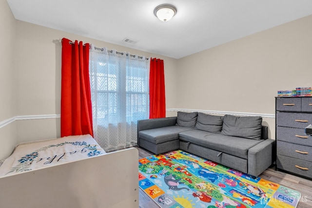 interior space with visible vents and wood finished floors