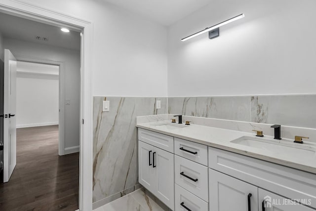 bathroom featuring vanity and tile walls