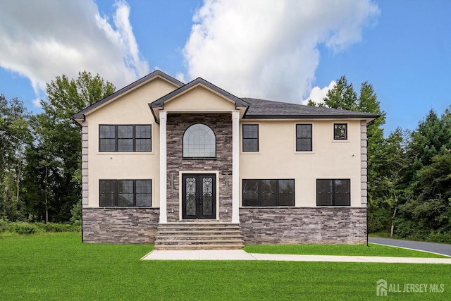 view of front of house with french doors and a front lawn