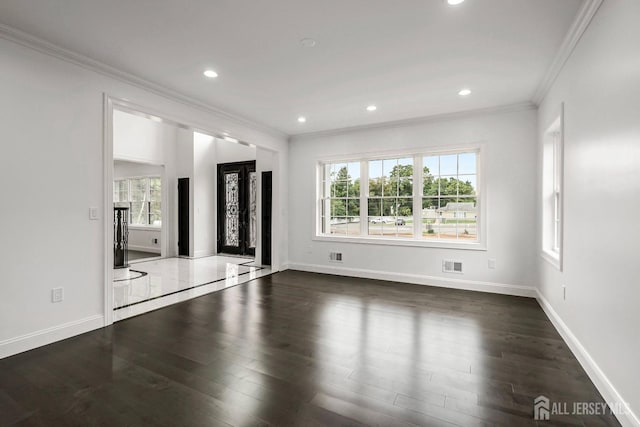 unfurnished living room featuring dark hardwood / wood-style floors and ornamental molding