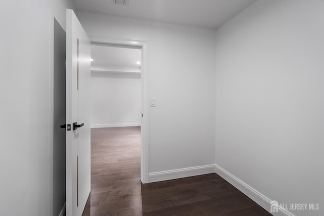 hallway featuring dark hardwood / wood-style flooring