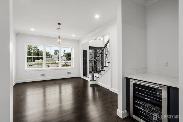 interior space with wine cooler, dark hardwood / wood-style floors, and ornamental molding