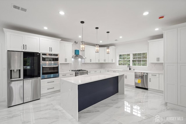 kitchen featuring a center island, hanging light fixtures, stainless steel appliances, extractor fan, and white cabinets