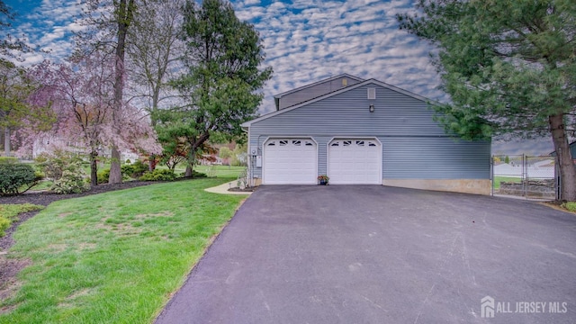 view of front of home featuring an attached garage and asphalt driveway