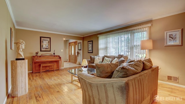 living room featuring light wood-style floors, baseboards, and ornamental molding